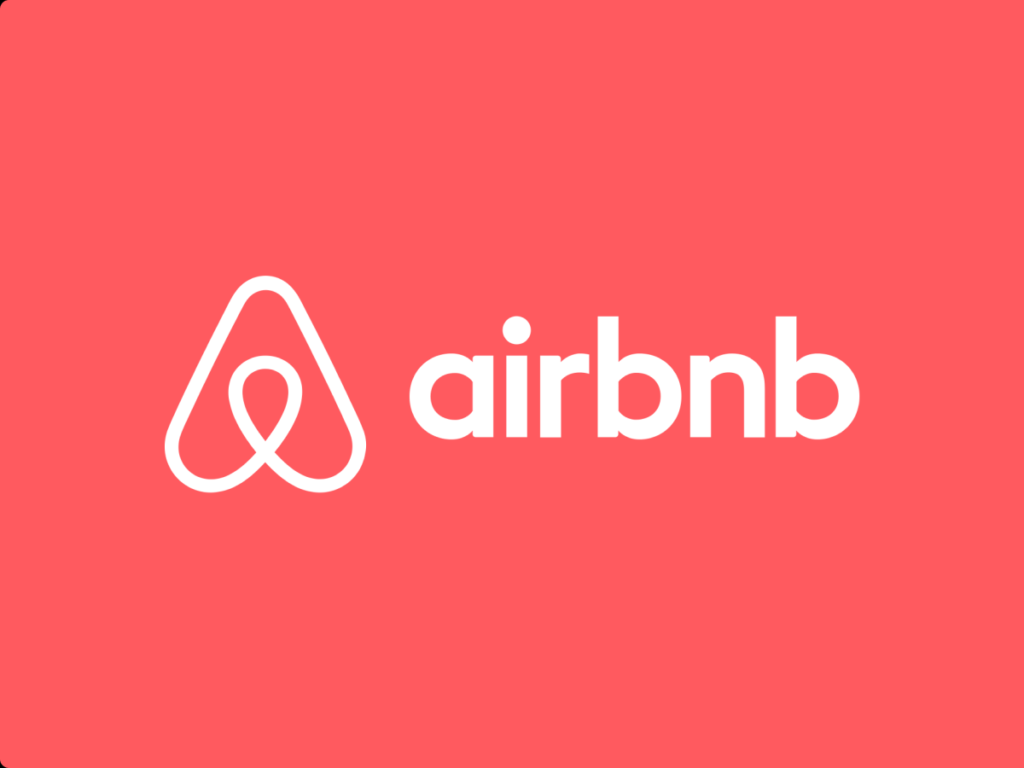 Airbnb logo with a world map in the background, symbolizing global reach and connection through unique accommodations.